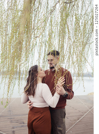 Romance outdoors dancing. Happy young couple dancing in stylish clothes. Romantic and spontaneous date moment 125027264
