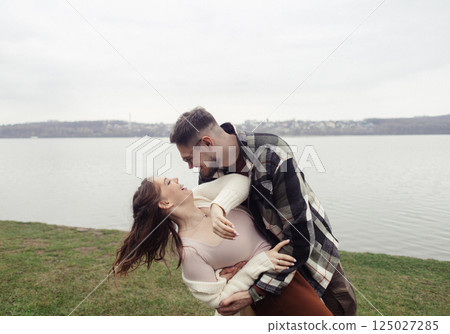 Romance outdoors dancing. Happy young couple dancing in stylish clothes. Romantic and spontaneous date moment Romance outdoors dancing. Happy young couple dancing in stylish clothes. Romantic and spontaneous date moment 125027285