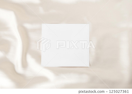 Satin fabric and empty white paper 125027361