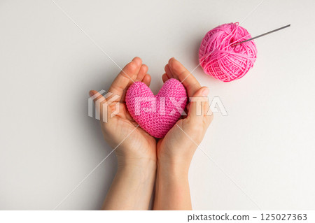 Hands holding crochet heart Hands holding crochet heart 125027363