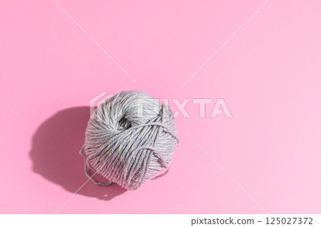 Ball of pink yarn on light background Ball of pink yarn on light background 125027372