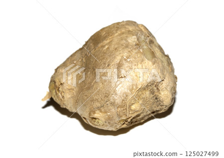Sliced chunk of fresh ginger root on a white background 125027499