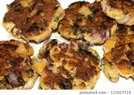 Close up of fried fish cakes or vegetable patties fritters juicy and tasty Close up of fried fish cakes or vegetable patties fritters juicy and tasty 125027518