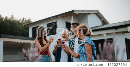 Family toasting with wine during spring family barbecue. 125027564
