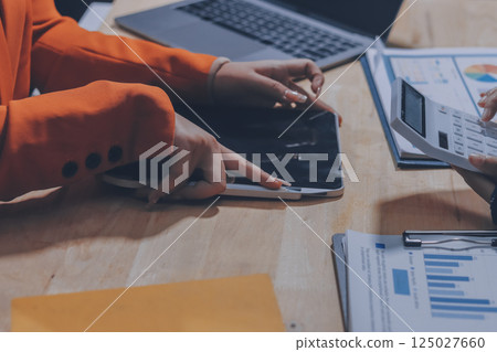 Businesswoman or accountant working Financial investment on calculator, calculate, analyze business and marketing growth on financial document data graph, Accounting, Economic, commercial concept. 125027660