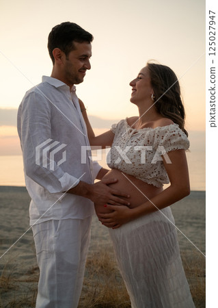 Love Grows as Couple Awaits Baby by the Ocean 125027947