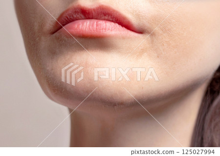 A woman's chin grows blonde and dark hair. A beard grows. 125027994