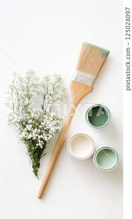 Flat Lay of Paintbrush, Green Paint, and White Flowers 125028097