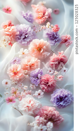 A fantastic composition of pastel-colored flowers blooming on soft fabric. A fantastic composition of pastel-colored flowers blooming on soft fabric. 125028325