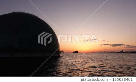 Dome and sun setting over the sea Dome and sun setting over the sea 125028401
