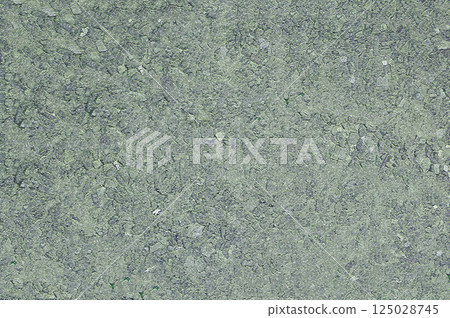 Close-up of an open concrete surface with a filler on which small stones are visible Close-up of an open concrete surface with a filler on which small stones are visible 125028745