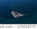 A bird's eye image of a large fishing vessel retrieving its nets.  125028773
