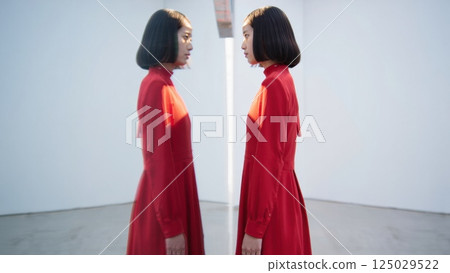 Two identical people fave to face, doppelganger concept, twin, double Two identical people fave to face, doppelganger concept, twin, double 125029522