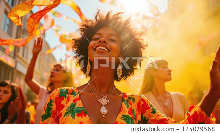 African american woman in colorful floral dress celebrating under festive flags. Summer festival, Juneteenth, Caribbean carnival, Pride month or cultural diversity celebration concept 125029568