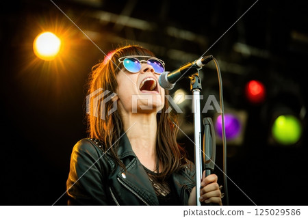 singer on stage singing in the microphone, concert, party, rave singer on stage singing in the microphone, concert, party, rave 125029586