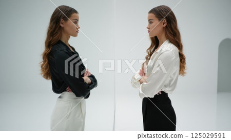 Two identical people fave to face, doppelganger concept, twin, double 125029591