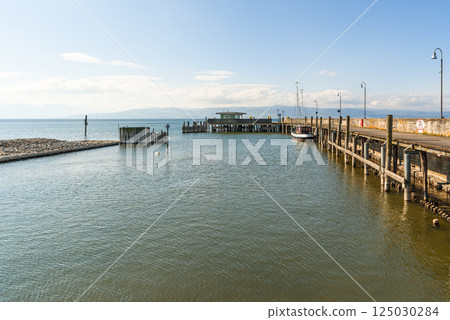 Pier with a moored boat on Lake Constance, Germany 125030284