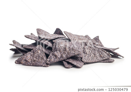Dark nachos chips isolated on white background. 125030479