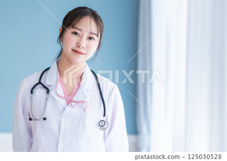 Portrait of a young female doctor on a white background 125030528