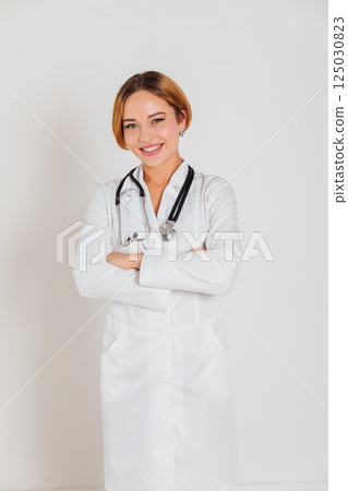 woman doctor with stethoscope in hospital smiling 125030823