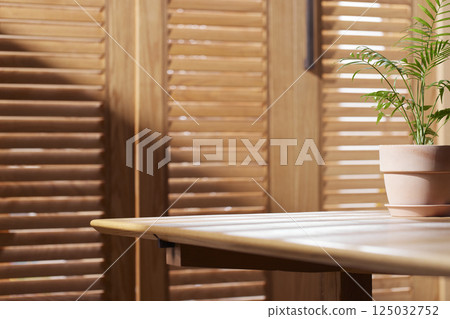 Sunlight and Shadows in a Cozy Wooden Interior. 125032752