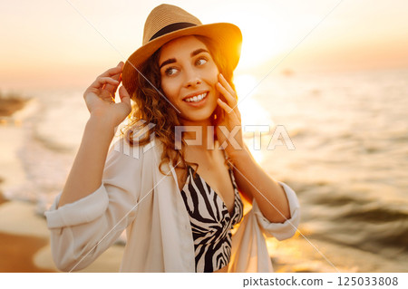 Happy woman on beach in summer style fashion trend outfit carefree and happy, feeling freedom. Happy woman on beach in summer style fashion trend outfit carefree and happy, feeling freedom. 125033808