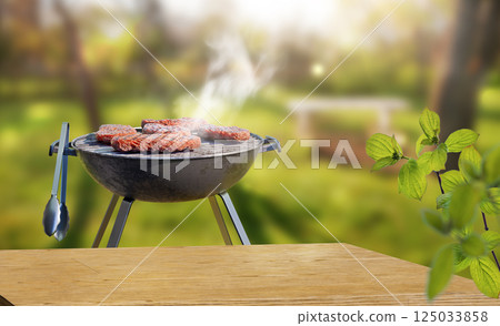 summer time in backyard garden with grill BBQ, wooden table, blurred background 125033858