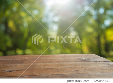 Wooden table and natural blurred background 125033879