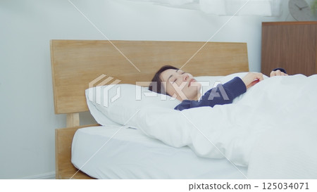 A woman sleeping in bed A woman sleeping in bed 125034071