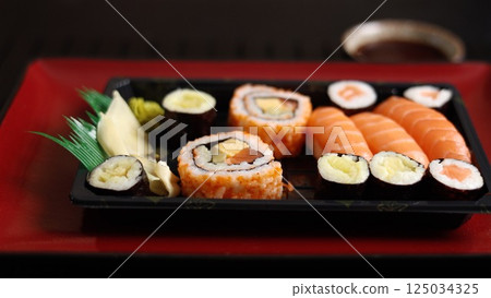 Sushi on vibrant red plate, showcasing health benefits of fresh, eco-friendly seafood. Enjoy meal that is not only delicious but also good for planet, embracing best of sustainable dining. 125034325