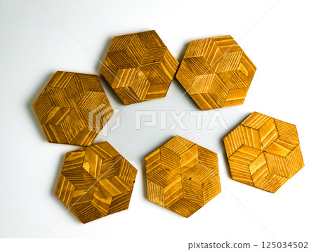 Six wooden hot plate stands in hexagon shape isolated on white background 125034502