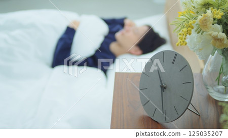 A woman sleeping in bed A woman sleeping in bed 125035207