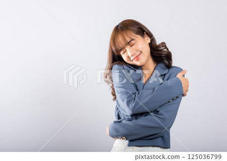 Happy beautiful young smiling Asian businesswoman hugging herself remember moment studio short isolated on white background, Self care and self esteem concept, Lifestyle female love yourself carefree 125036799