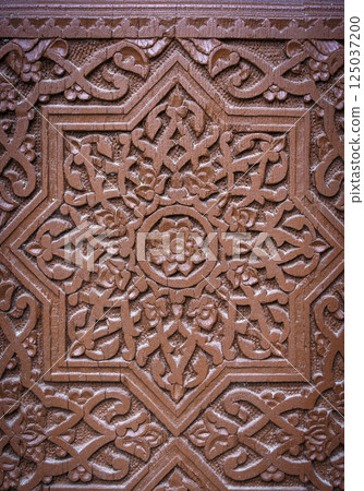 Wooden carving ornament decorative background. Geometric pattern on wooden facade Wooden carving ornament decorative background. Geometric pattern on wooden facade 125037200