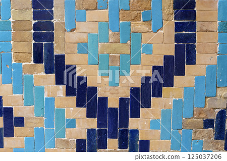 Old tiles background. Vintage colored ceramics with a pattern on the facade 125037206