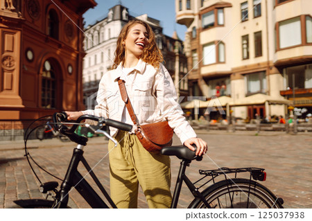 Portrait of beautiful young woman enjoying time on bicycle. Active lifestyle. Eco transport. 125037938