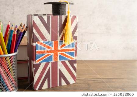 UK flag with graduate hat on english language book. 125038000