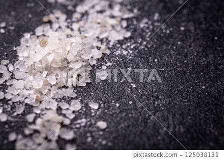 Natural sea salt crystals on dark background Natural sea salt crystals on dark background 125038131
