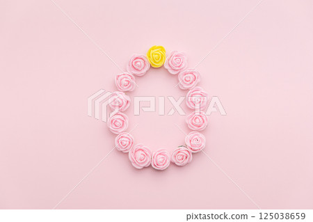 Pastel pink and yellow rosebuds egg shape on pink background. Versatile Easter-themed composition perfect for backgrounds, greeting cards, social media, and seasonal marketing. Pastel pink and yellow rosebuds egg shape on pink background. Versatile Easter-themed composition perfect for backgrounds, greeting cards, social media, and seasonal marketing. 125038659