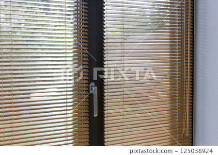 Close-Up of Wooden Blinds on Glass Door 125038924