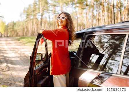 Stopping during a car trip. Young woman enjoying nature. Journey by car. Lifestyle, travel, tourism 125039273