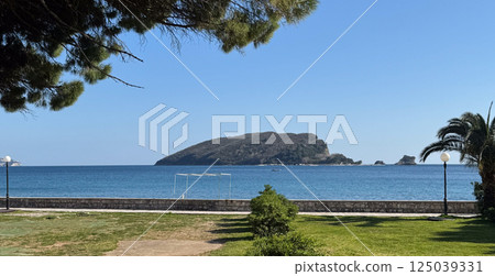 Scenic view of forested island surrounded by tranquil blue sea Scenic view of forested island surrounded by tranquil blue sea 125039331