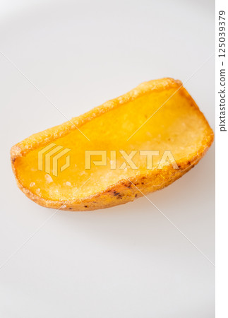 Single crispy potato dipper isolated against bright white background, fried to perfection 125039379