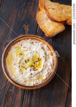Creamy baba ghanoush in wooden bowl with chili and olive oil Creamy baba ghanoush in wooden bowl with chili and olive oil 125039390