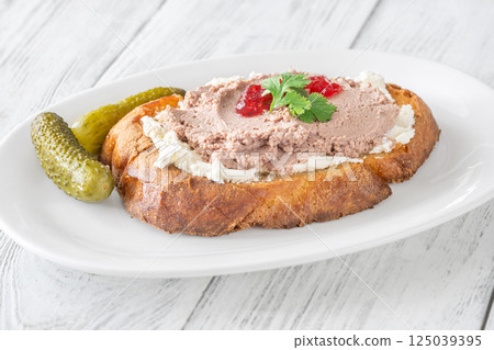 Gourmet sandwich layered with pate, cranberry jam, and cream cheese Gourmet sandwich layered with pate, cranberry jam, and cream cheese 125039395