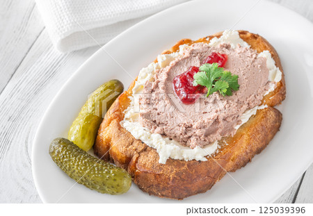 Gourmet sandwich layered with pate, cranberry jam, and cream cheese 125039396