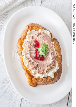 Gourmet sandwich layered with pate, cranberry jam, and cream cheese 125039397