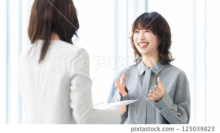 Two women/businesswomen having a meeting Two women/businesswomen having a meeting 125039823