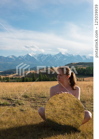 Woman in blue dress in summer Altai mountains 125039939
