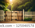 Golden Hour Glow on Rustic Wooden Gate Amidst Lush Greenery 125040578